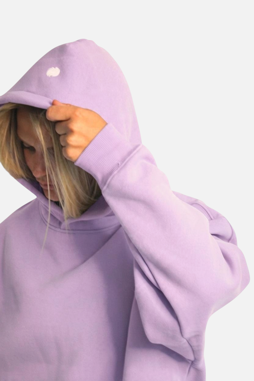 noora lavender brushed fleece hoodie with a boxy fit and hood, worn by a model looking down