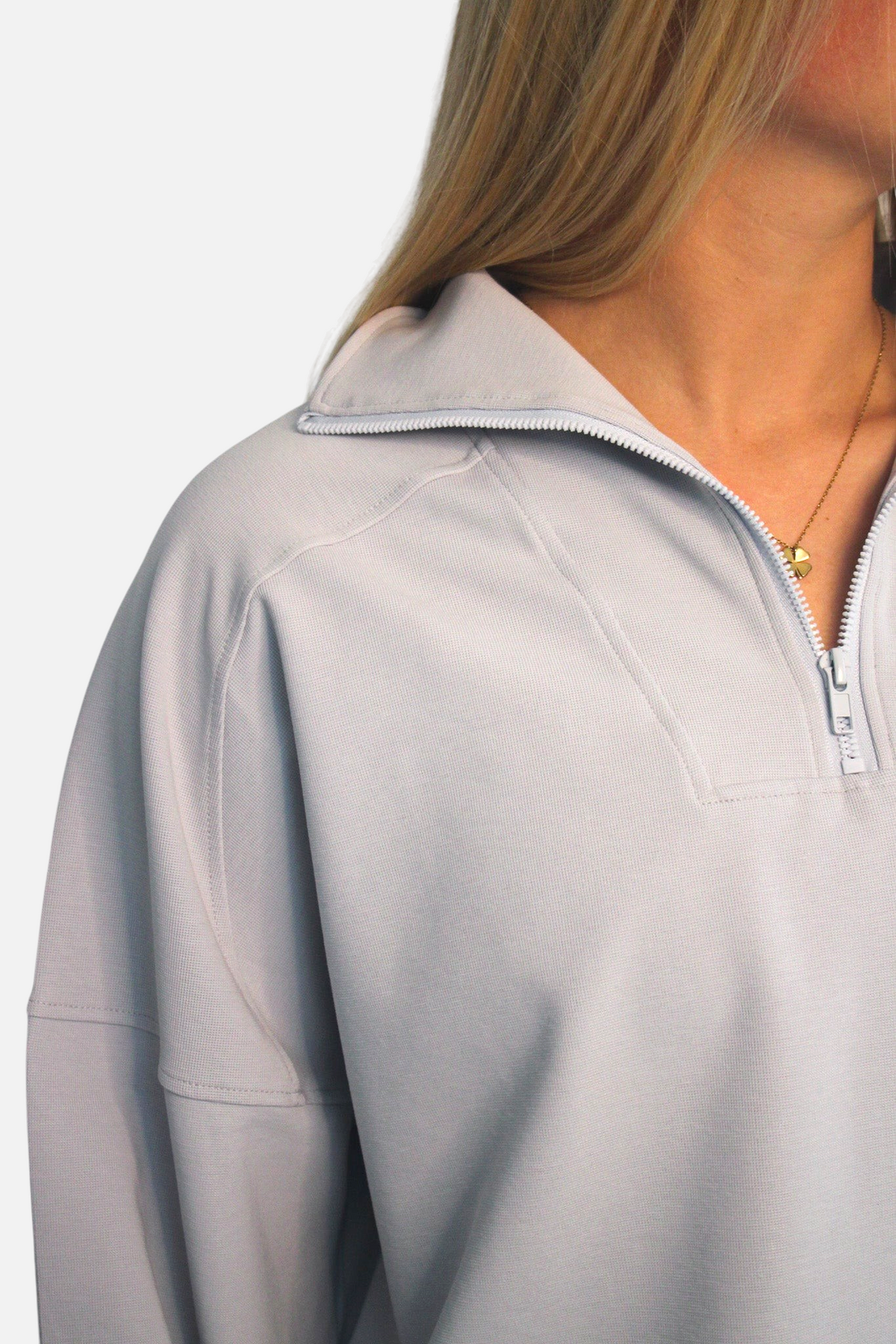 noora light grey 3/4 zip sweater with a relaxed fit and crewneck collar worn by a woman