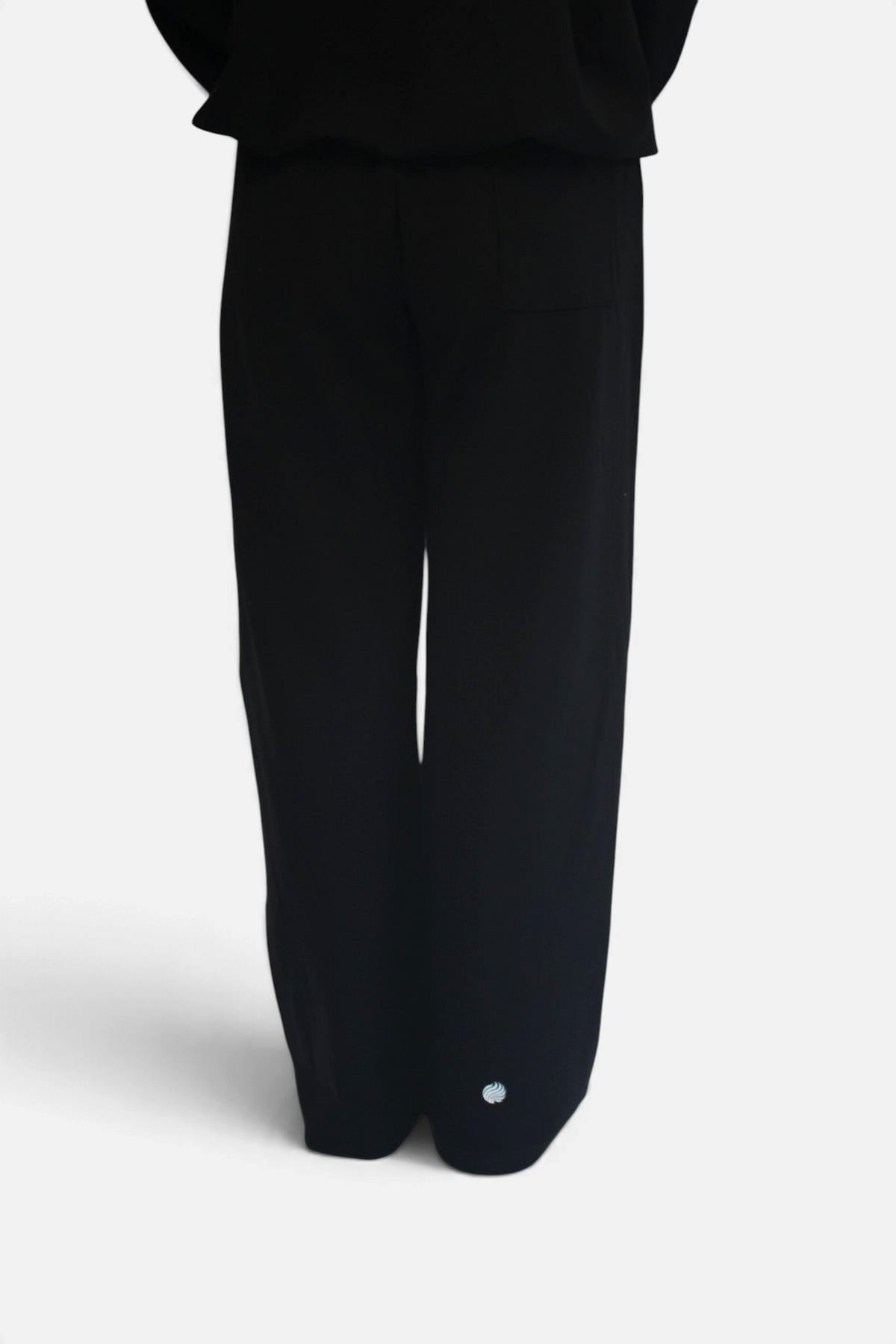 noora black straight fit joggers with adjustable waistband and subtle logo detail, worn by a model from behind
